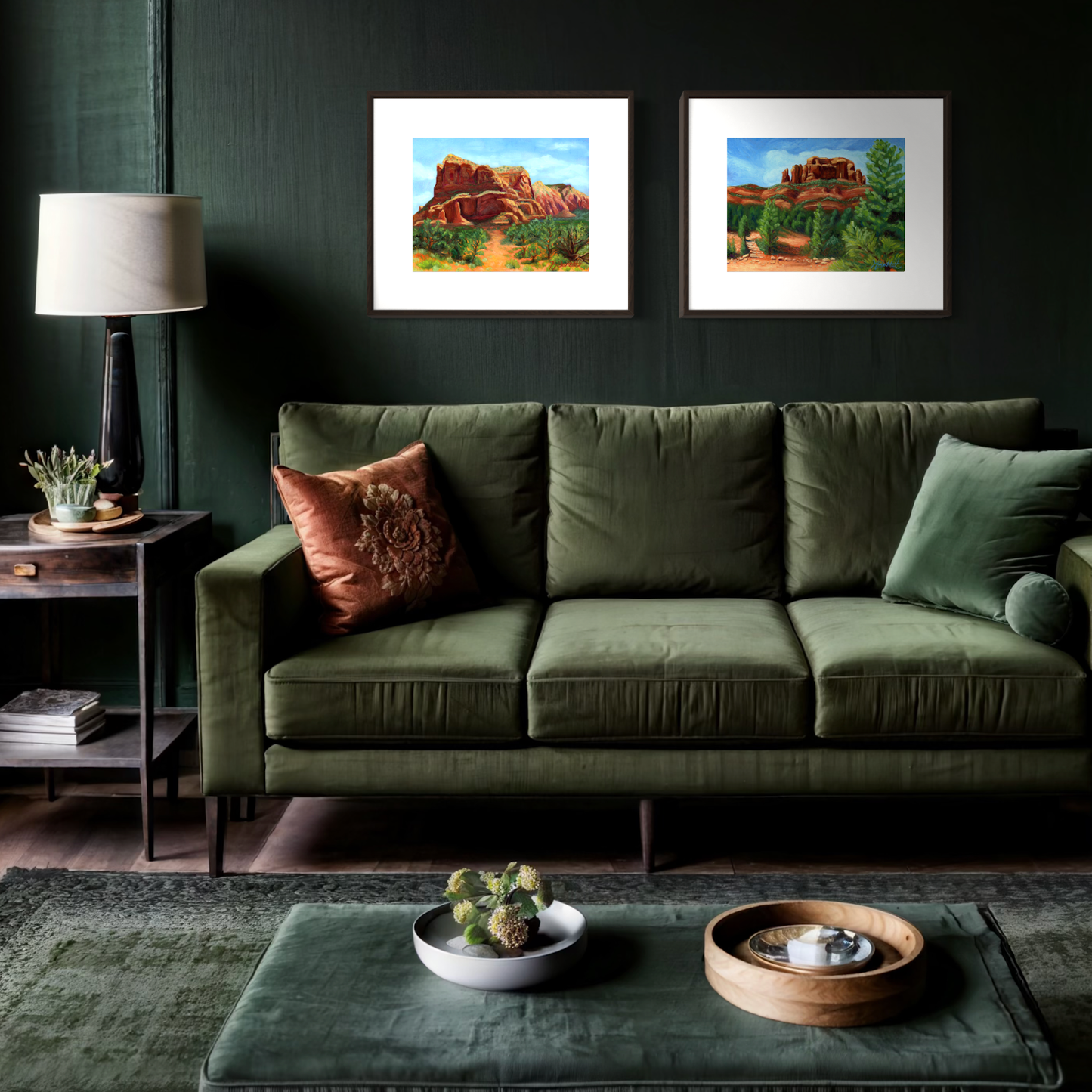 Green sofa in a living room with framed artwork on the wall.