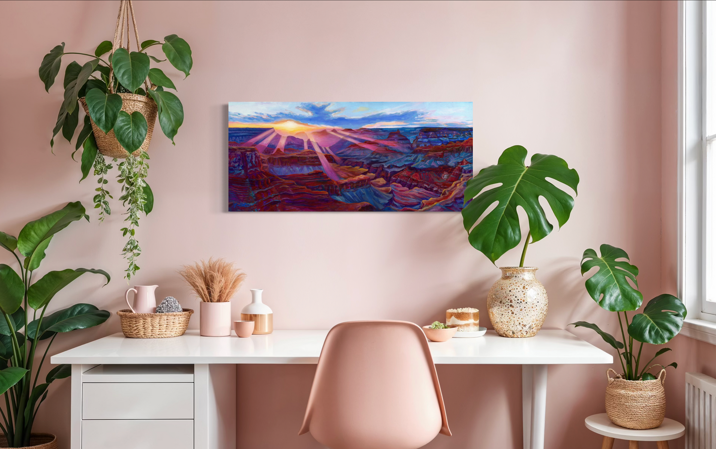 Modern home office with a desk, chair, and decorative plants against a pink wall.