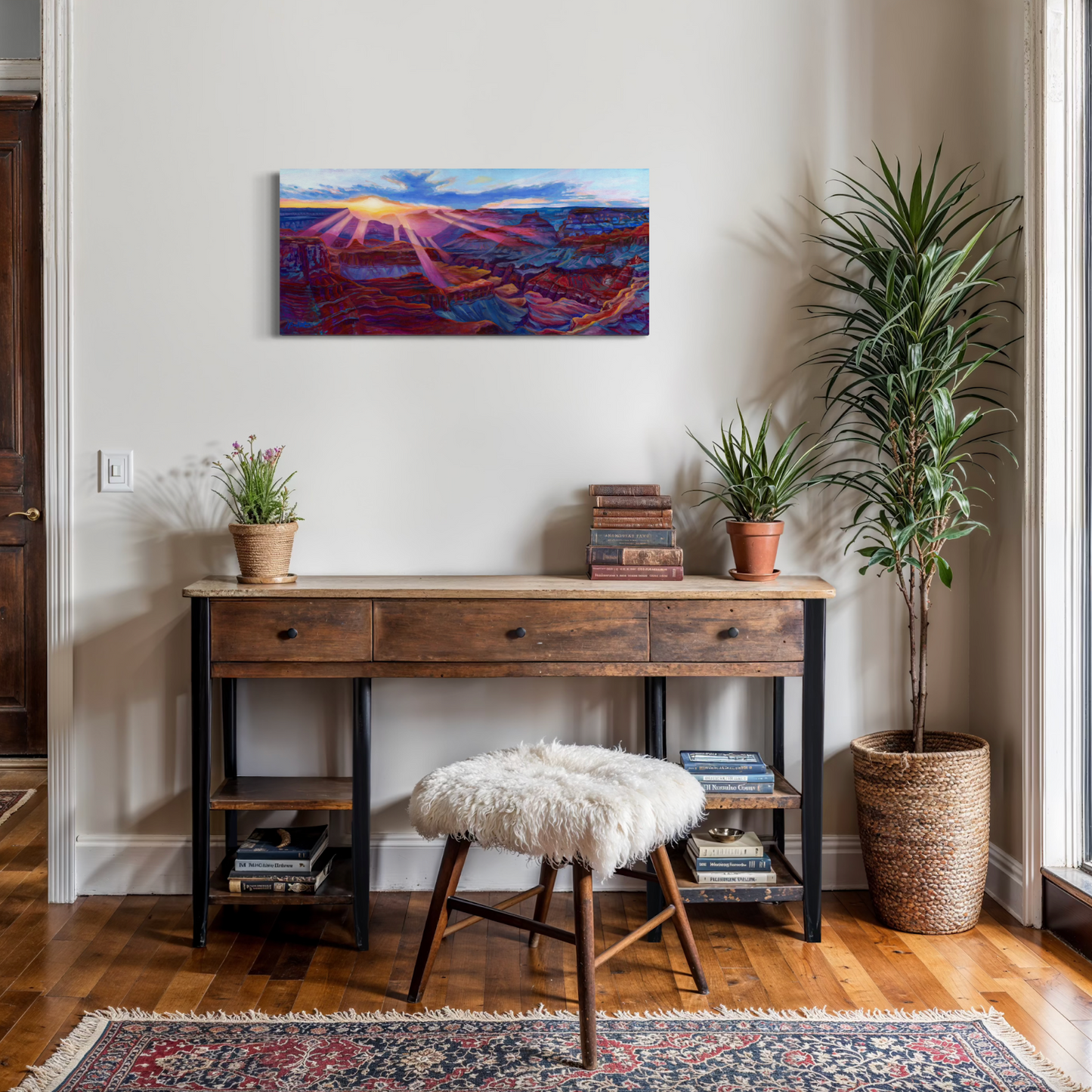 Wooden desk with a stool, plants, and a colorful painting in a room.
