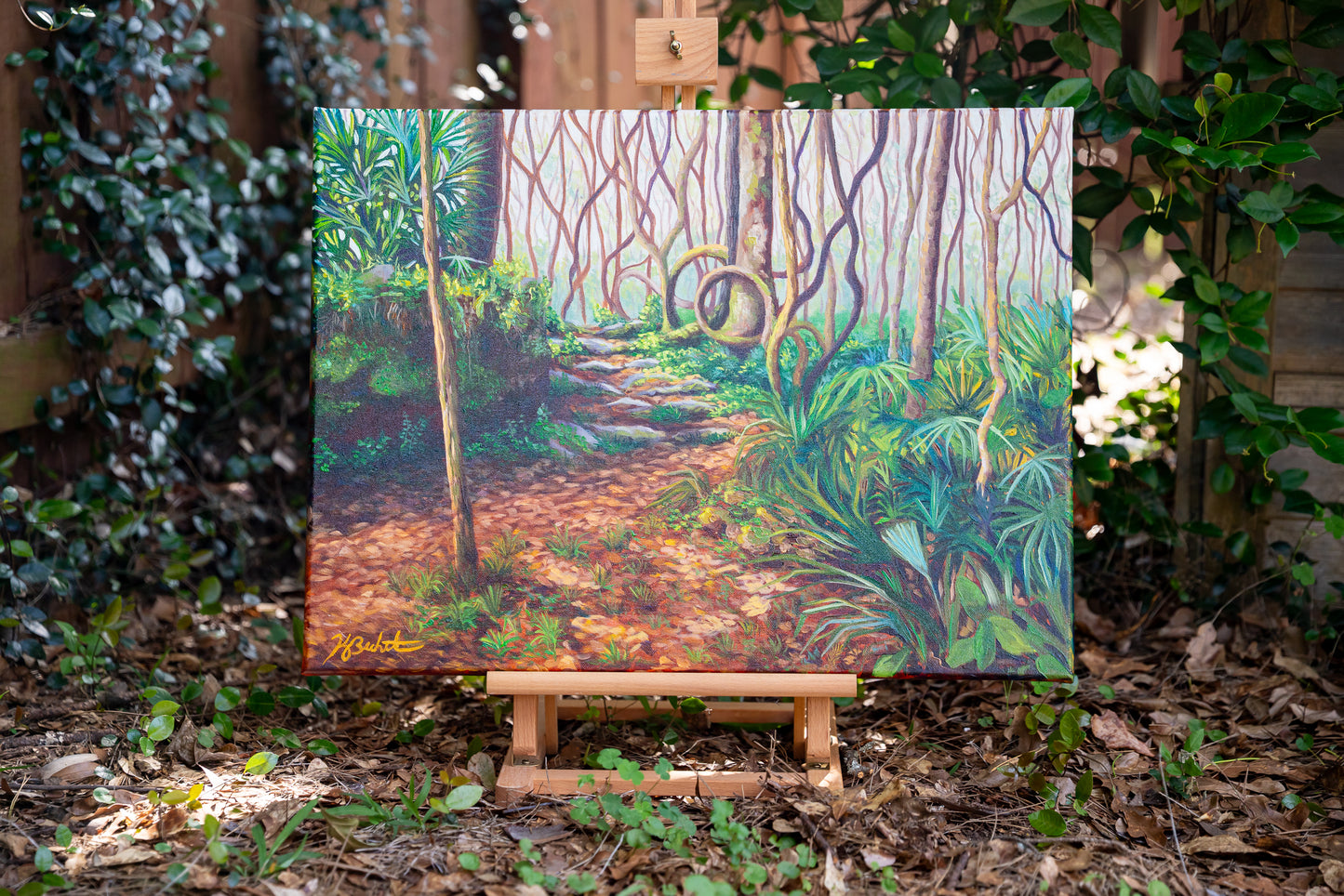 Painting of a forest scene on an easel outdoors