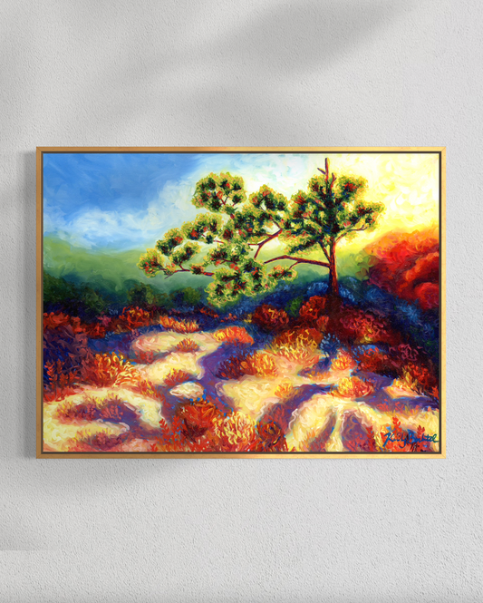 Framed painting of a landscape with a tree and stream on a white wall.