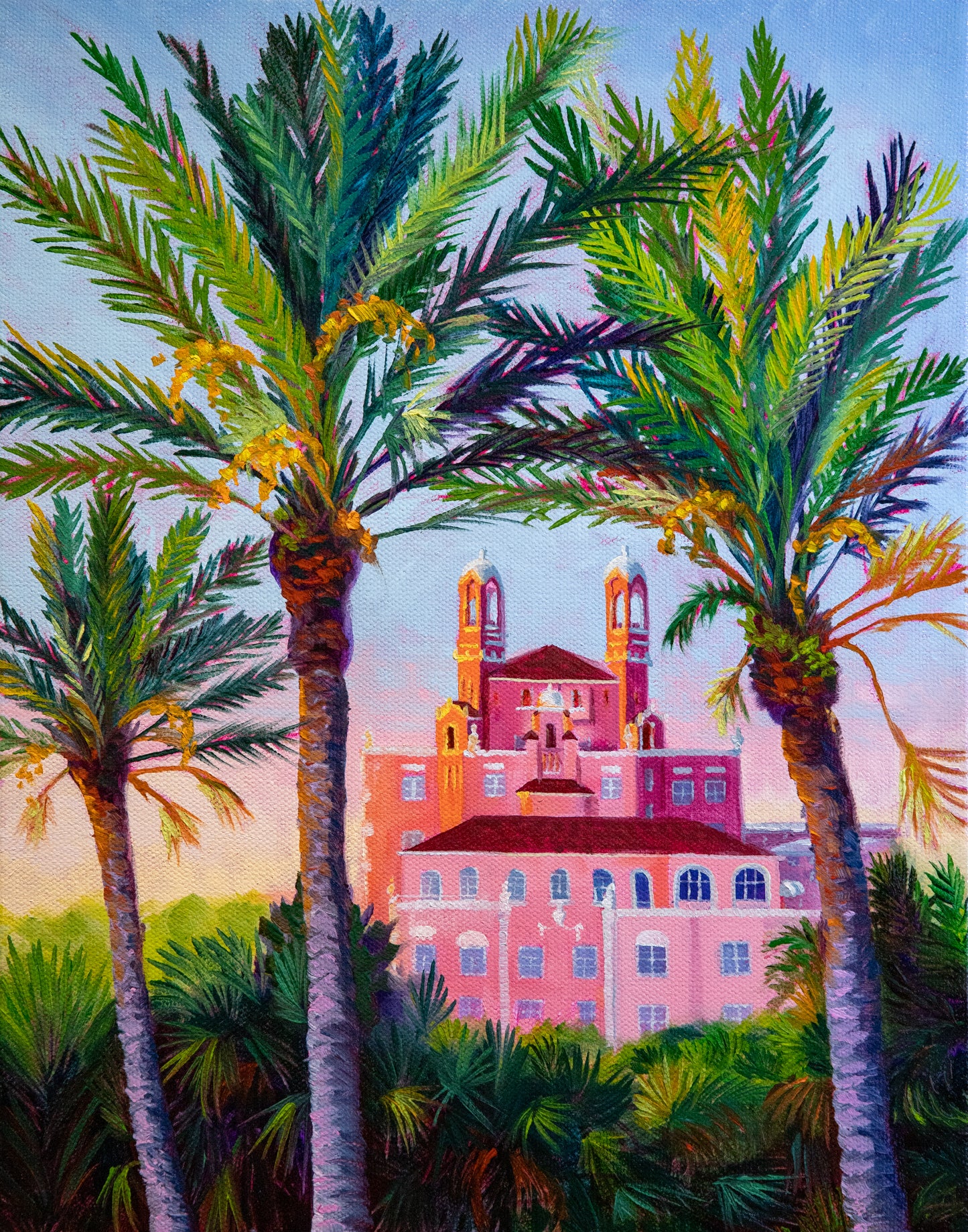Painting of an ornate pink building behind palm trees with a colorful sky.