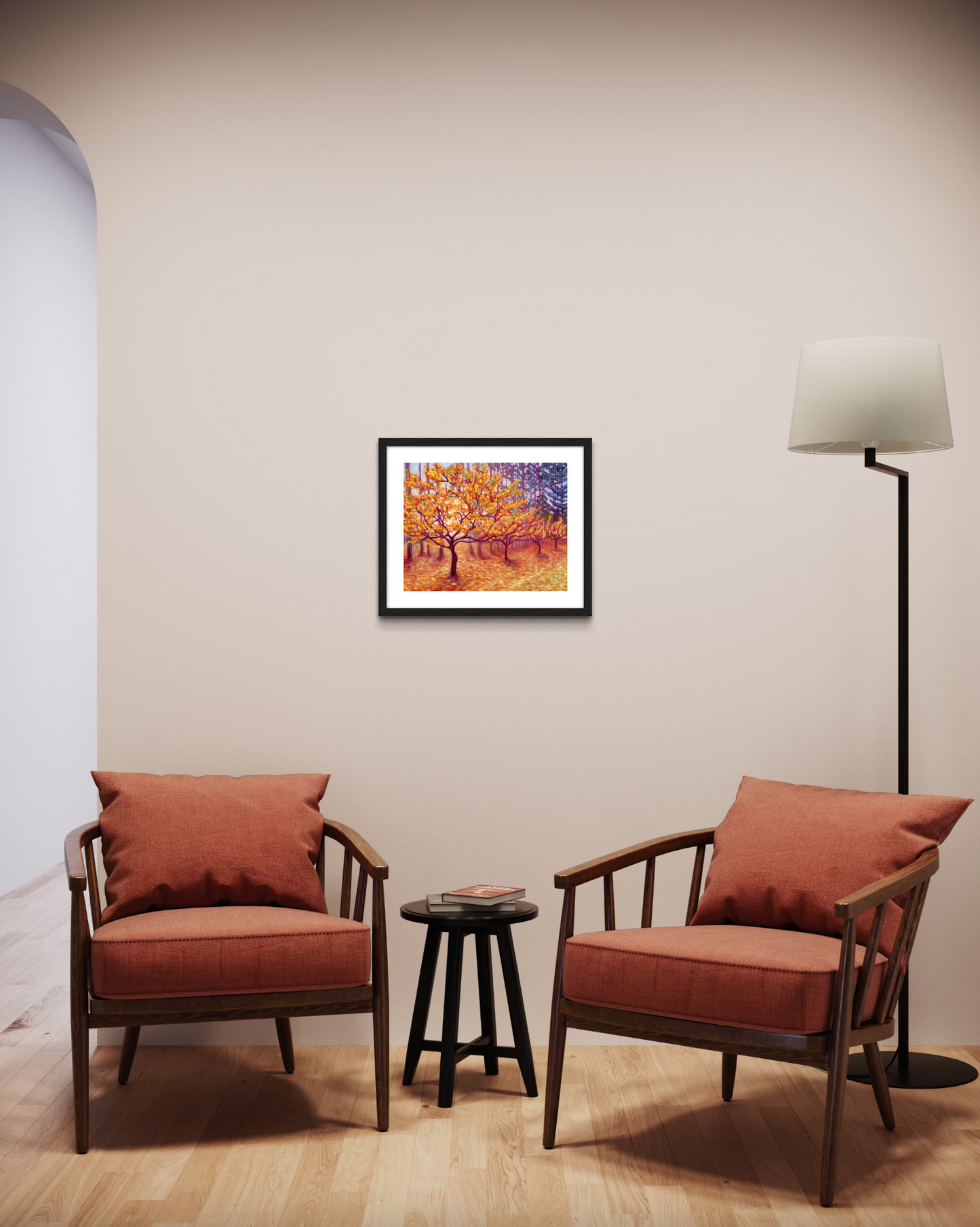 Two brown armchairs with cushions in a room with a framed picture of trees with golden leaves on the wall.