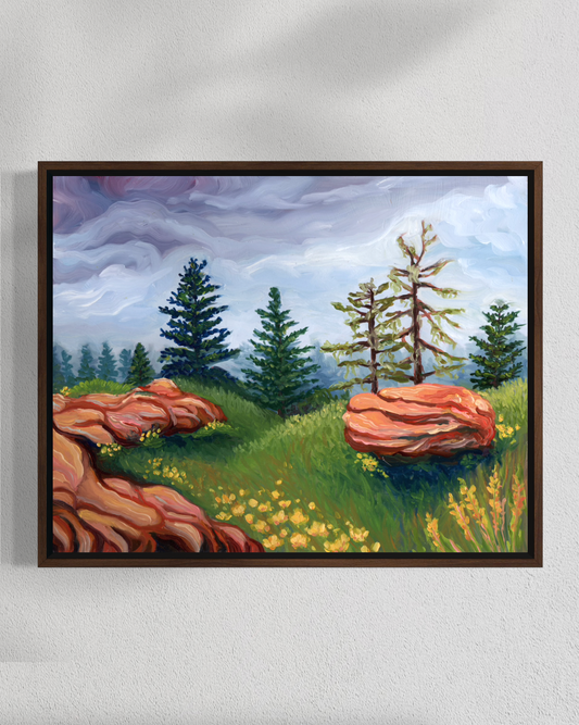 Framed painting of a landscape with trees and rocks on a white wall