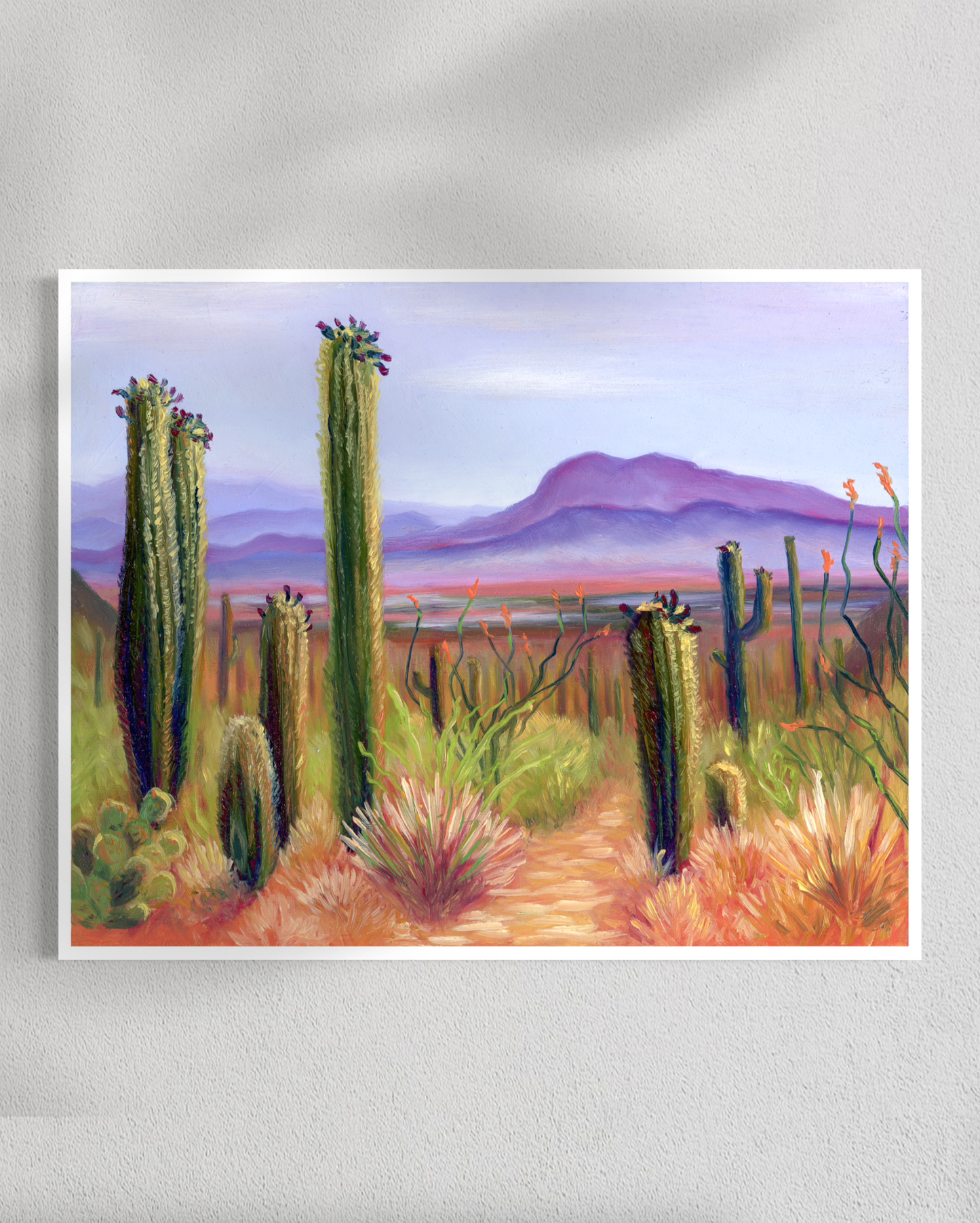 Painting of a desert landscape with cacti and mountains.