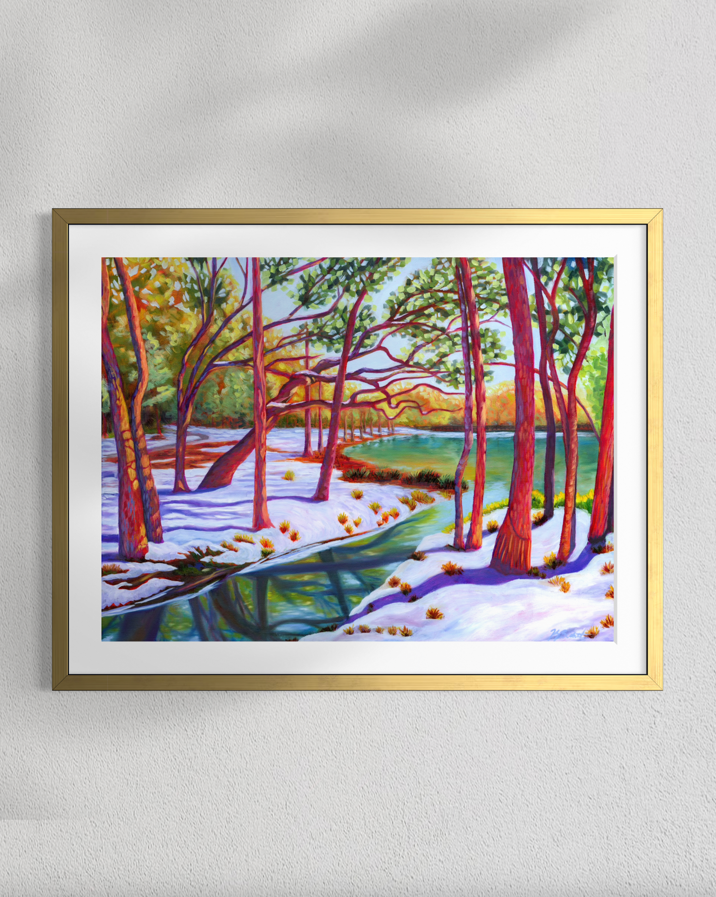 Framed painting of a snowy forest scene on a white wall