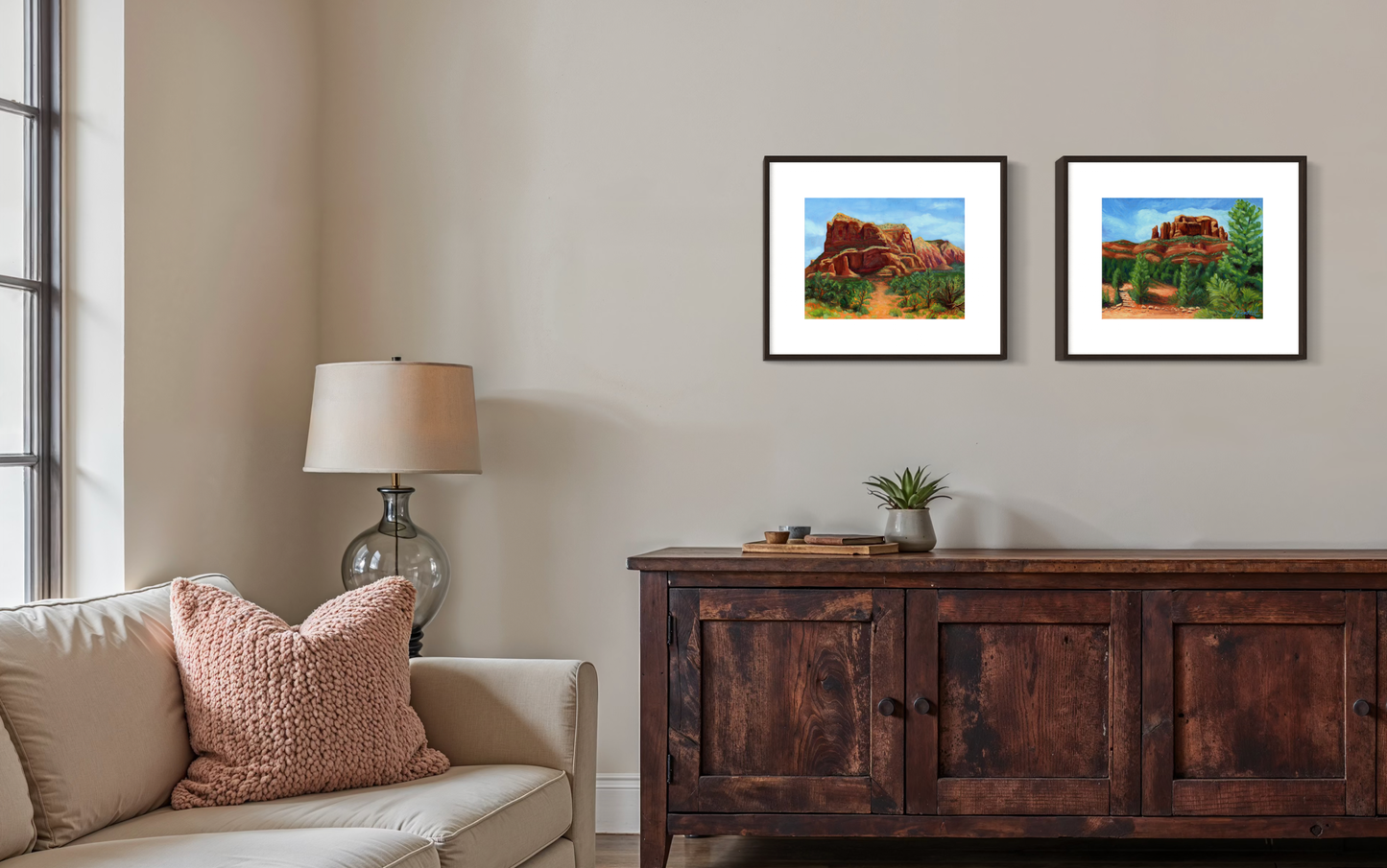 Living room with beige sofa, wooden sideboard, and framed landscape pictures on the wall.