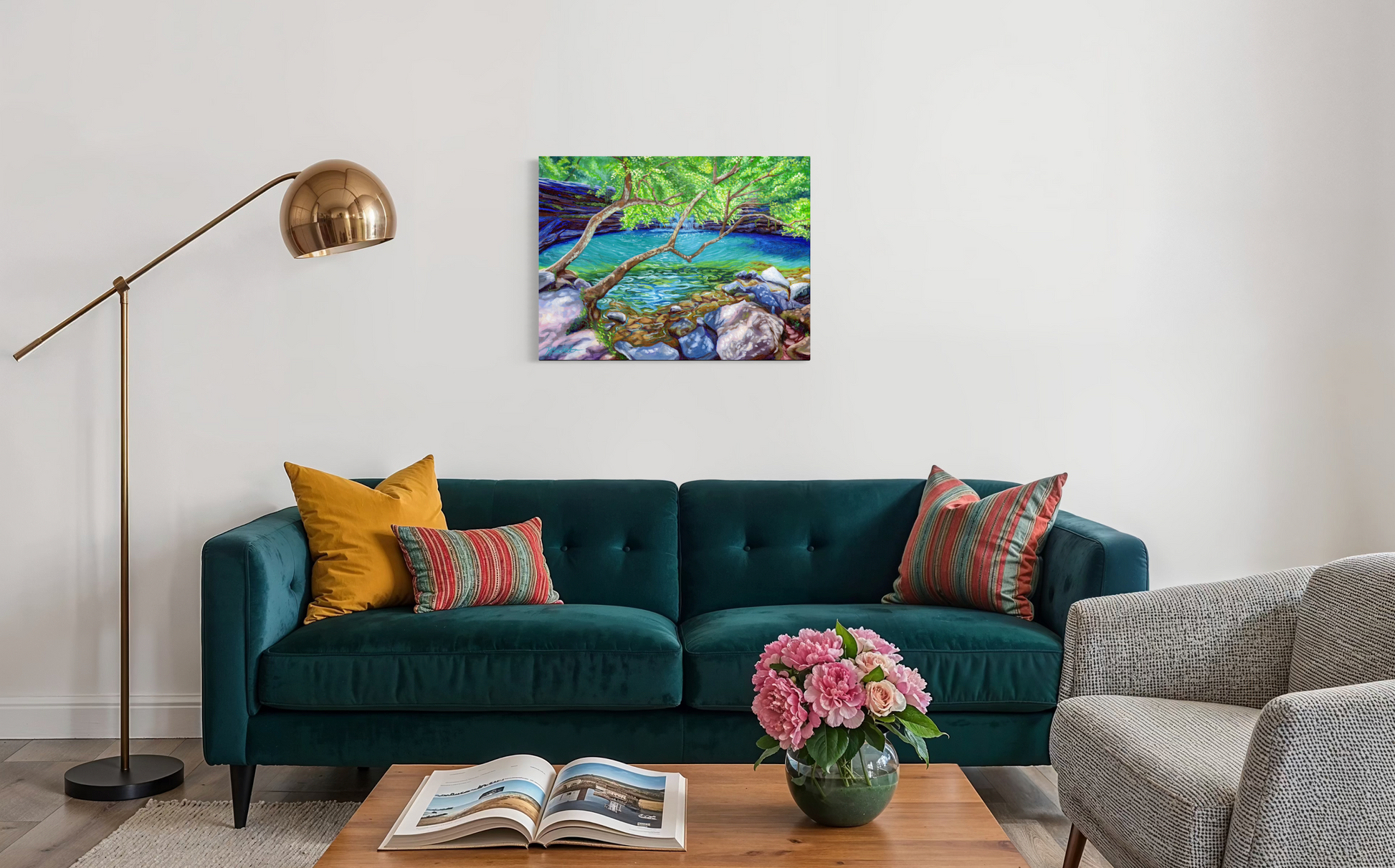 Living room with teal sofa, colorful pillows, and a painting of a nature scene on the wall.