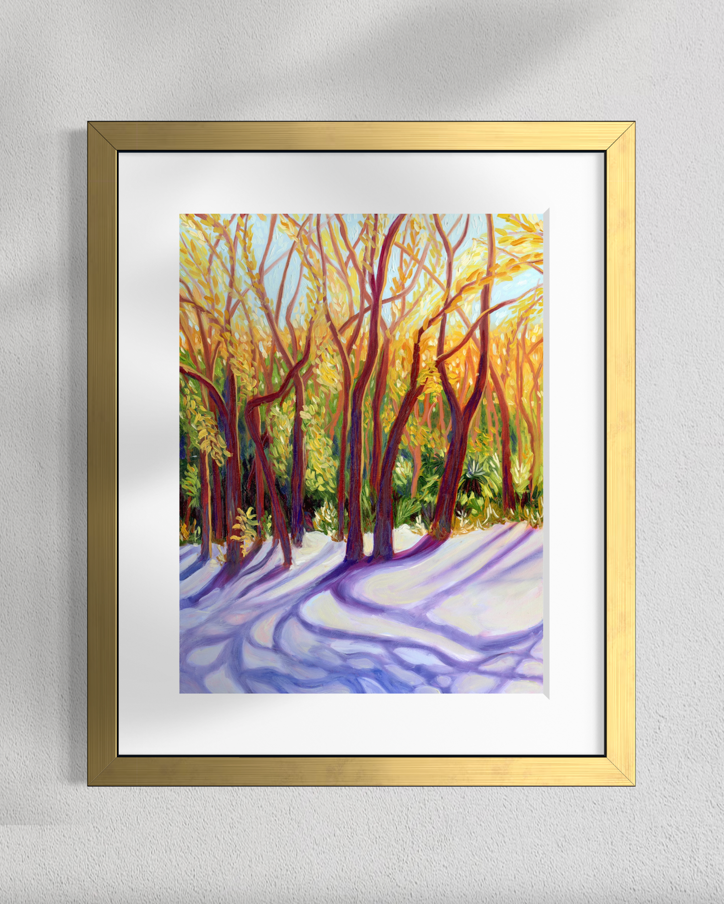 Framed painting of a forest scene with sunlight filtering through the trees on a gray wall.