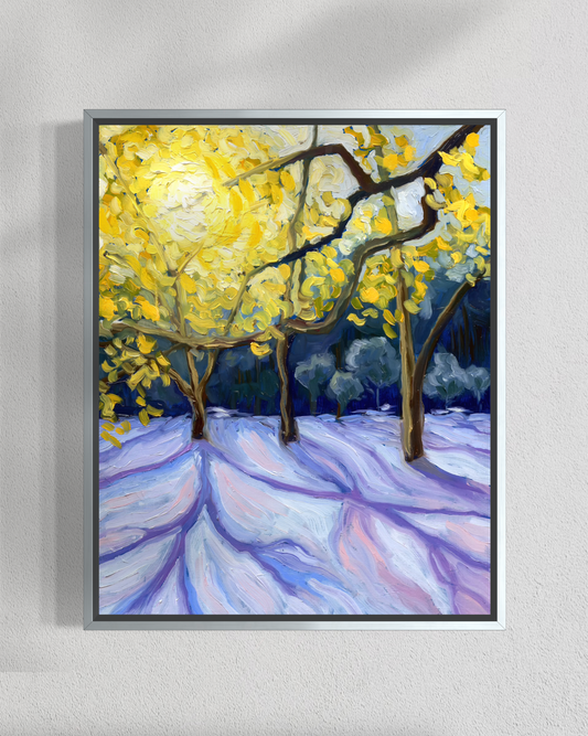 Framed painting of trees with yellow leaves on a snowy ground against a gray wall.