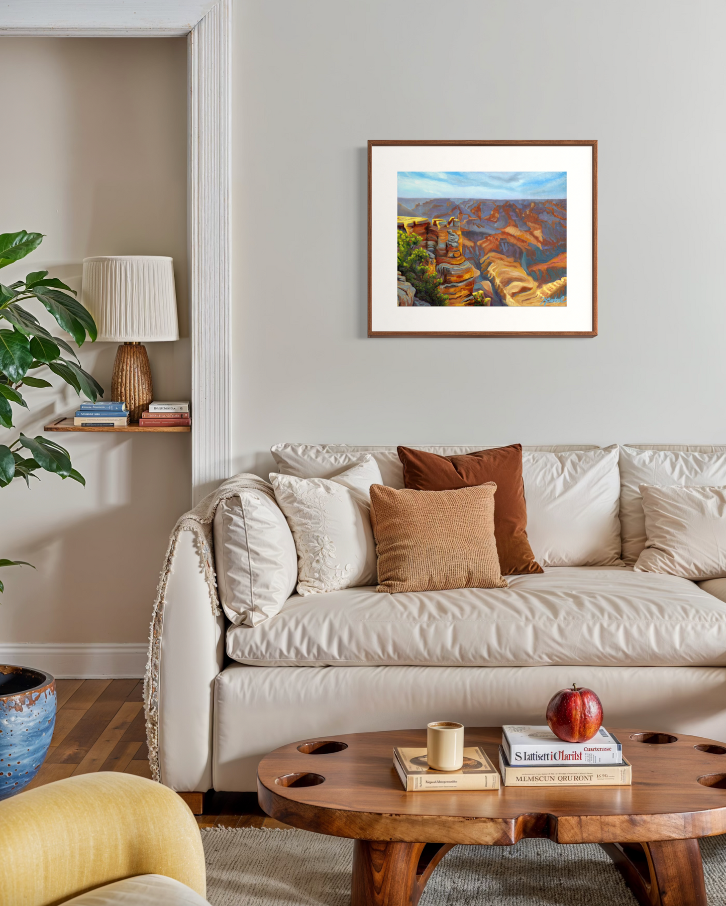Living room with a beige sofa, wooden coffee table, and framed artwork on the wall.