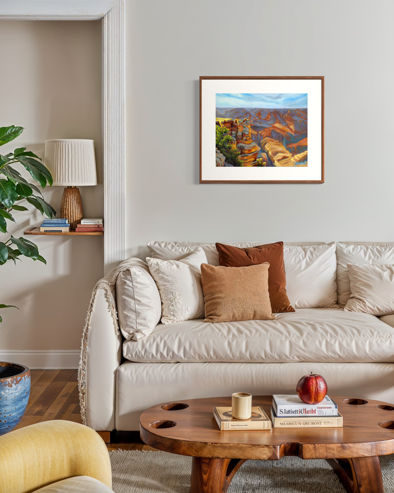 Living room with a beige sofa, wooden coffee table, and framed artwork on the wall.