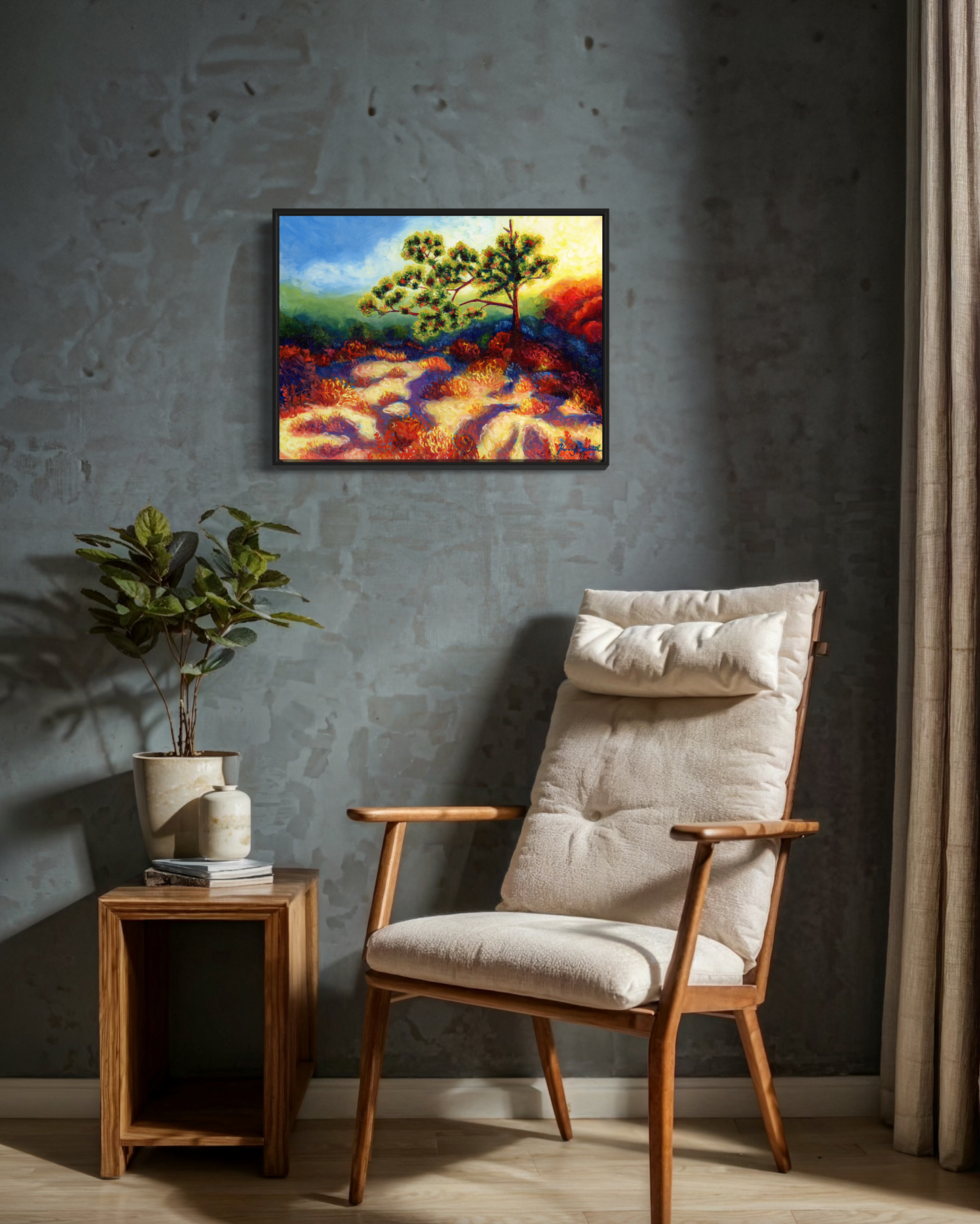 Beige armchair in a room with a landscape painting on the wall and a plant on a side table.