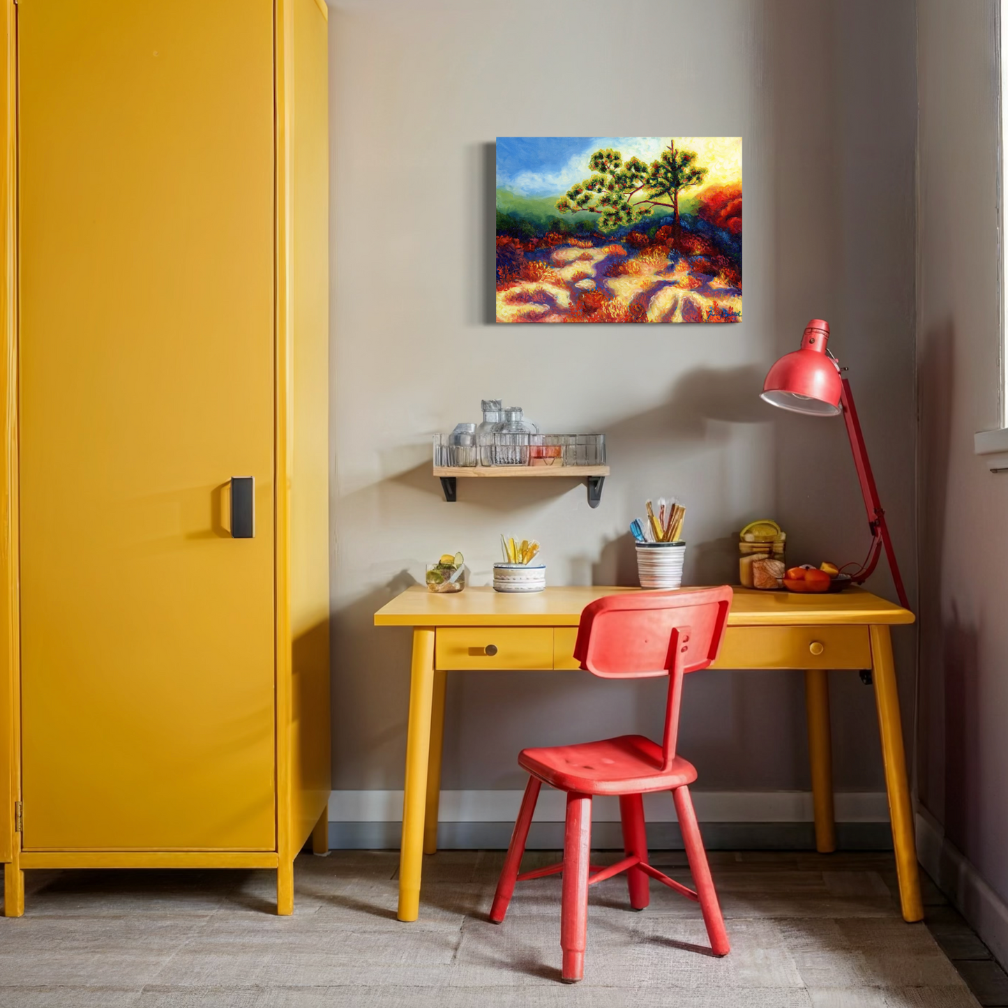 Small home office with a yellow cabinet, red chair, desk, and wall art.