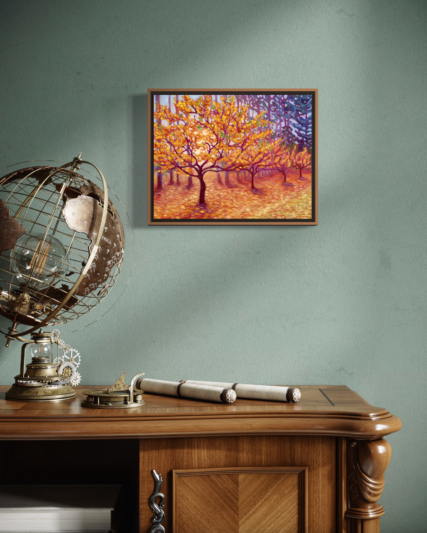 Framed artwork of a golden row of trees on a green wall above a wooden desk with decorative items.