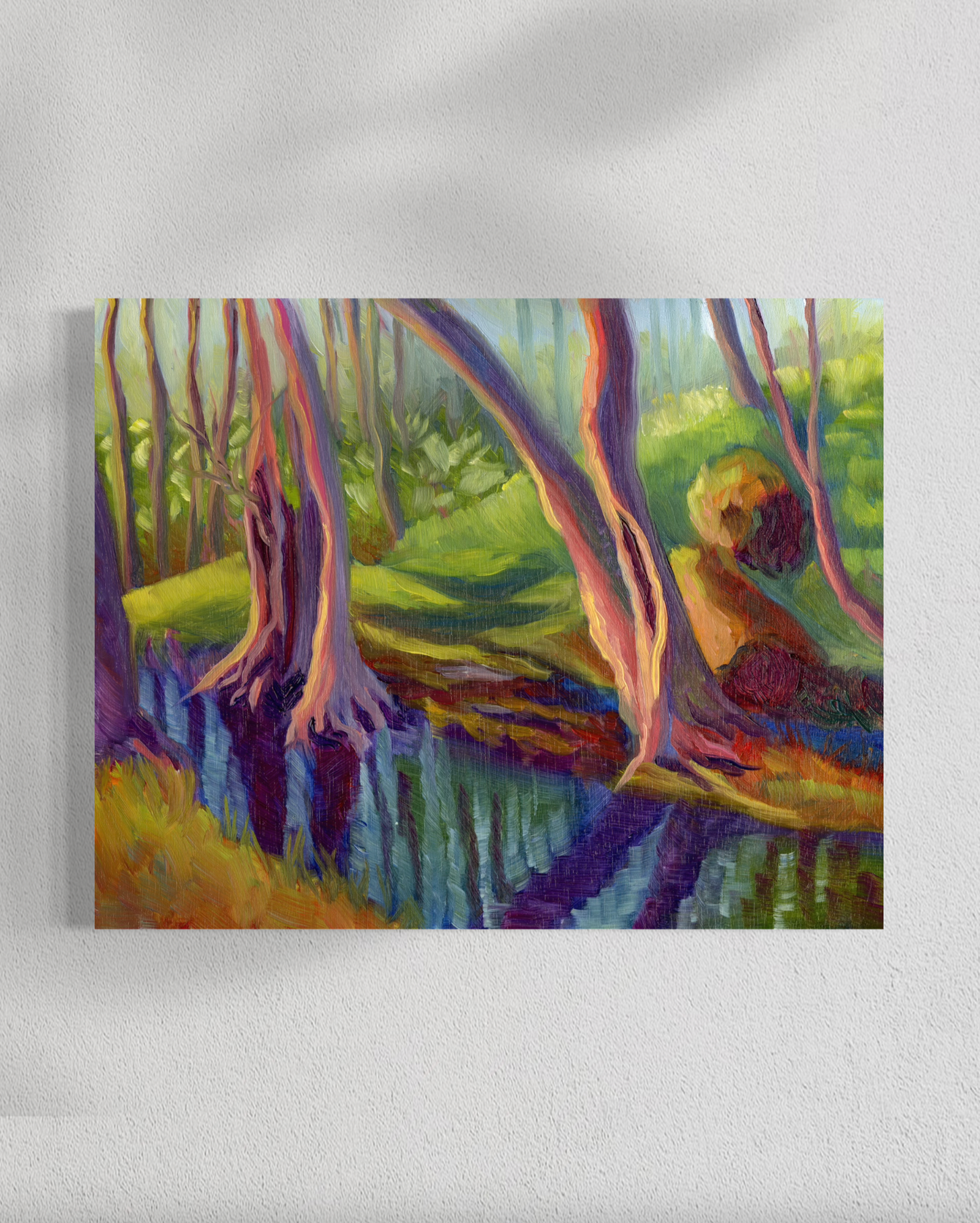 Colorful painting of a forest scene on a white wall
