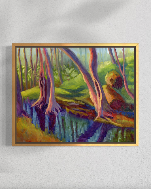 Framed painting of a forest scene with trees and a stream on a white wall.