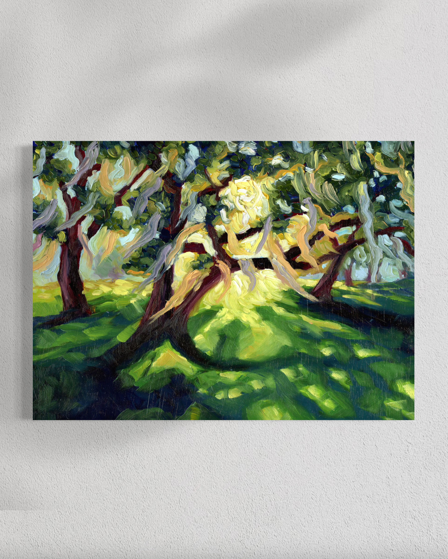 Painting of a tree with a bright light at its center on a white wall.