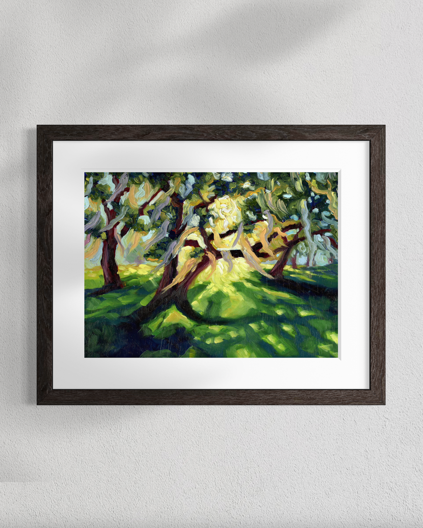 Framed painting of a tree with sunlight on a white wall