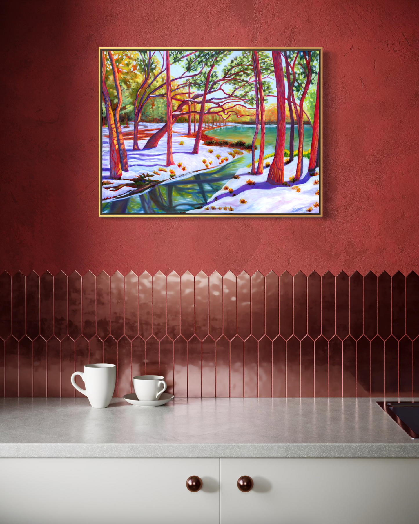 Kitchen with a painting of a snowy forest on the wall, two white mugs on the counter.