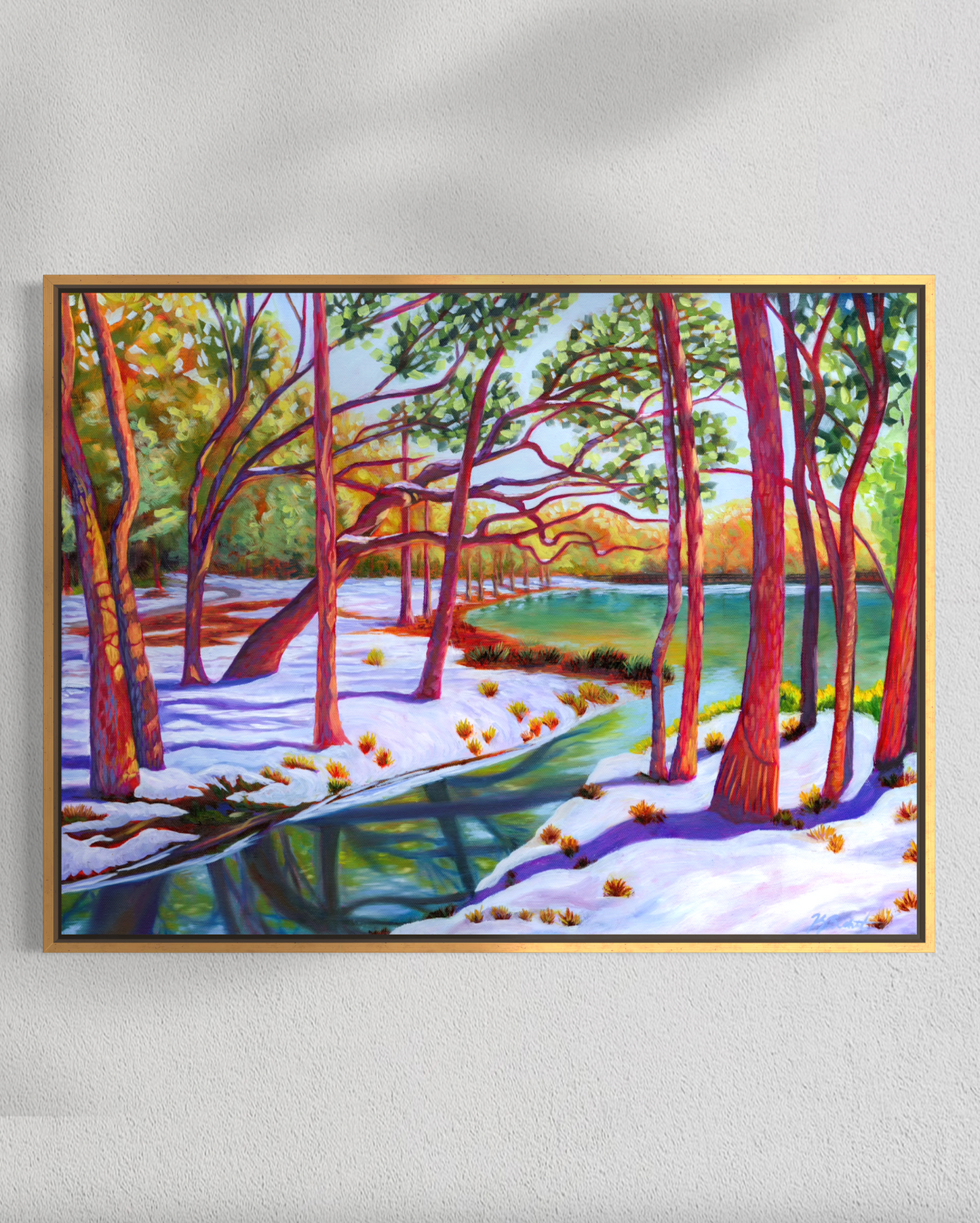 Framed painting of a snowy forest scene with trees and snow on a white wall.