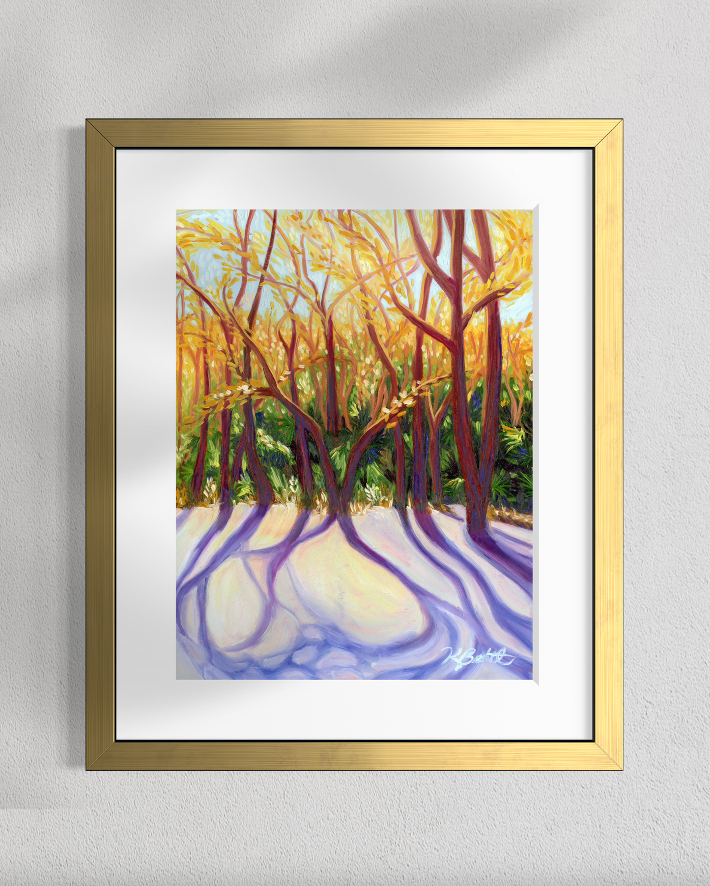 Framed artwork of a forest scene with trees and a path on a gray wall.