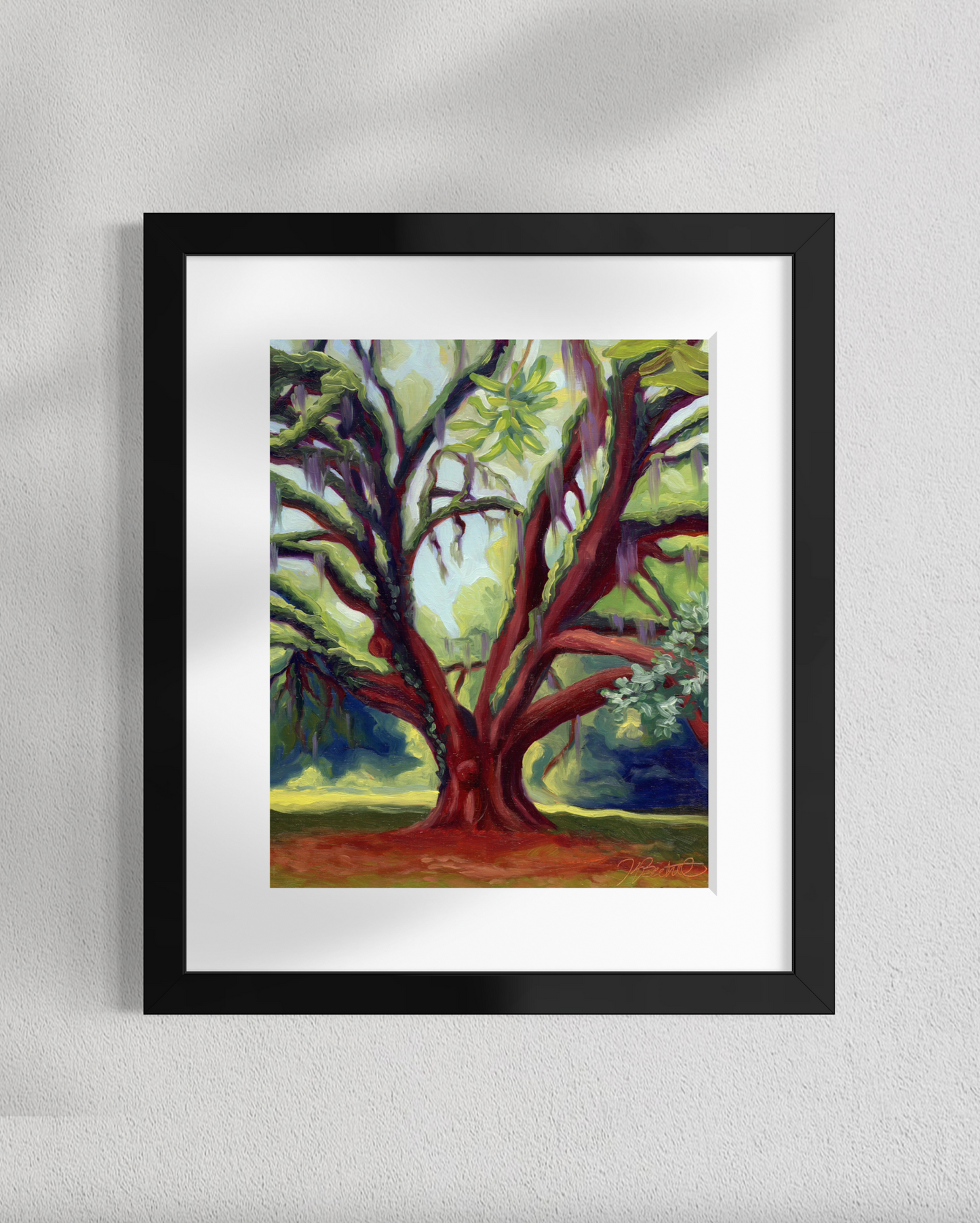 Framed painting of a large tree on a white wall
