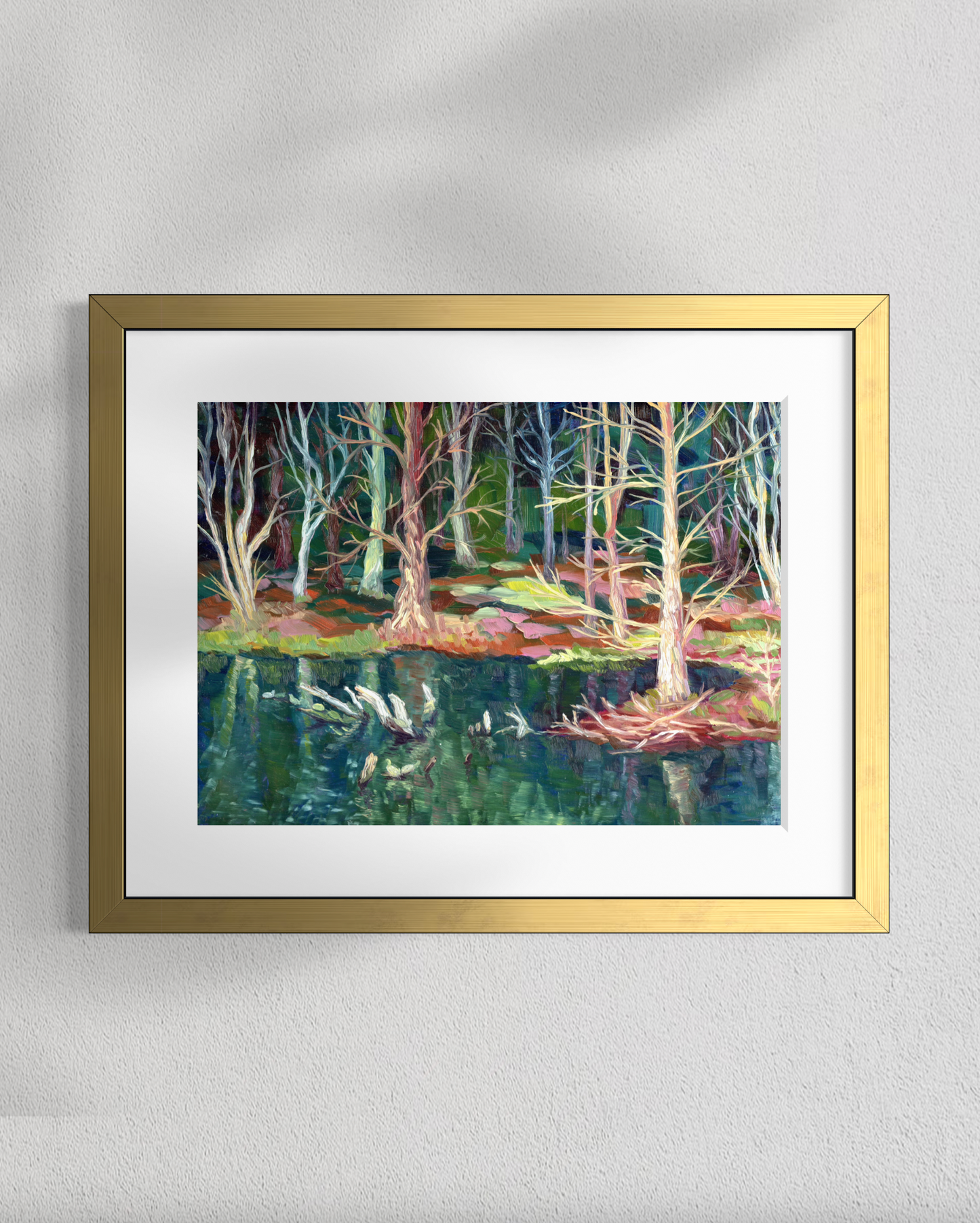 Framed painting of a forest scene with trees and water on a gray wall.