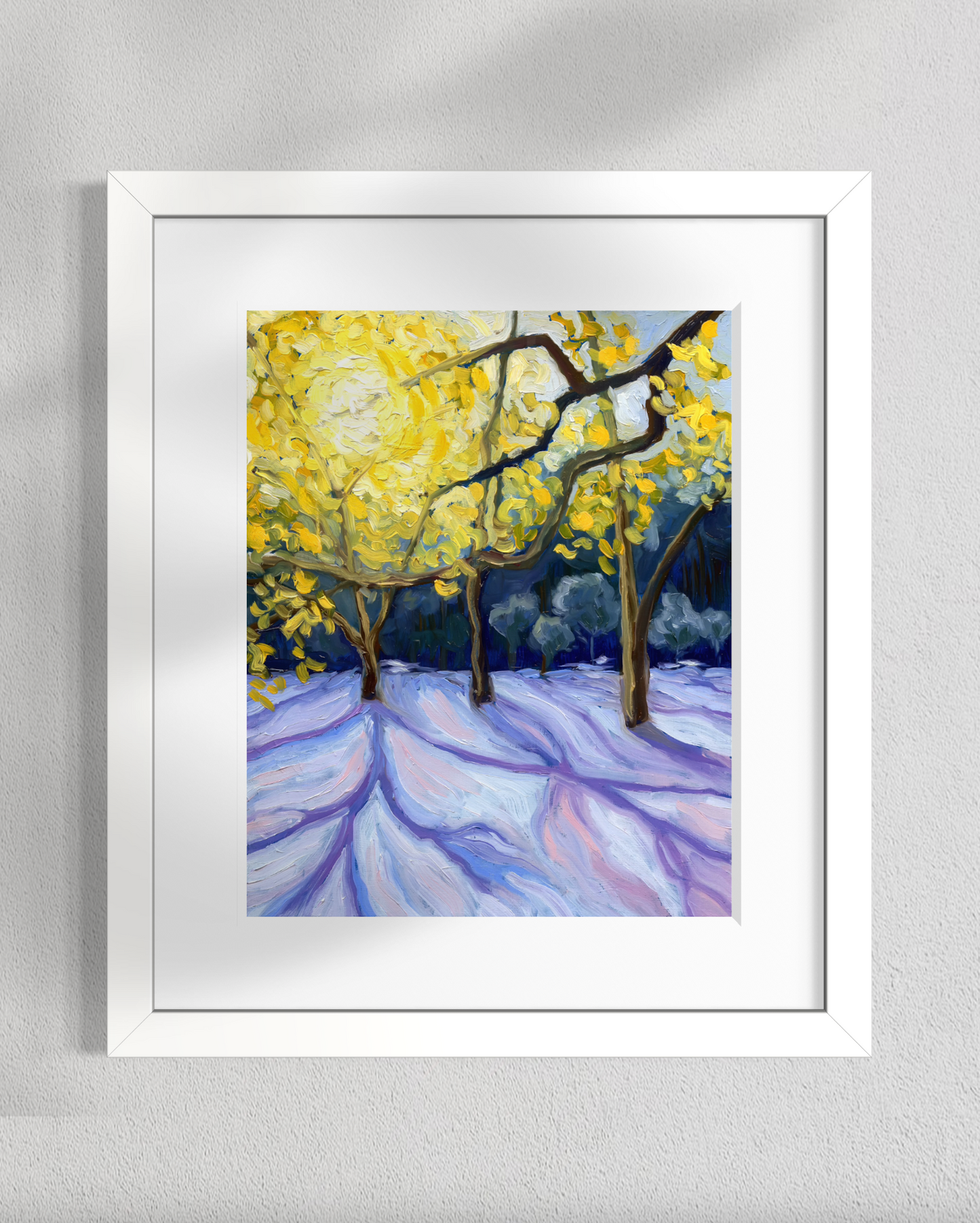 Framed painting of trees with yellow leaves on a gray wall
