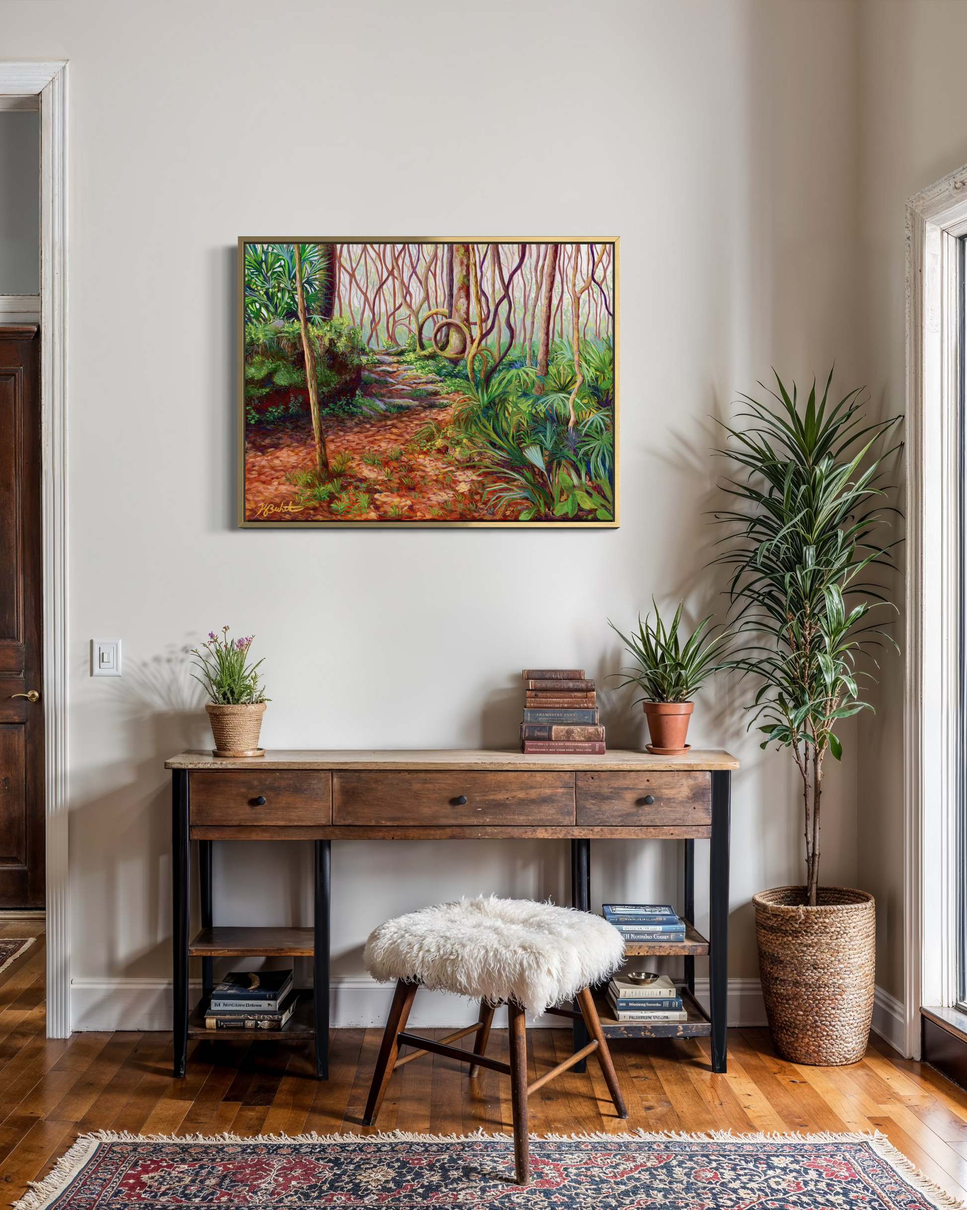 Room interior with a wooden console table, plants, and a painting on the wall.