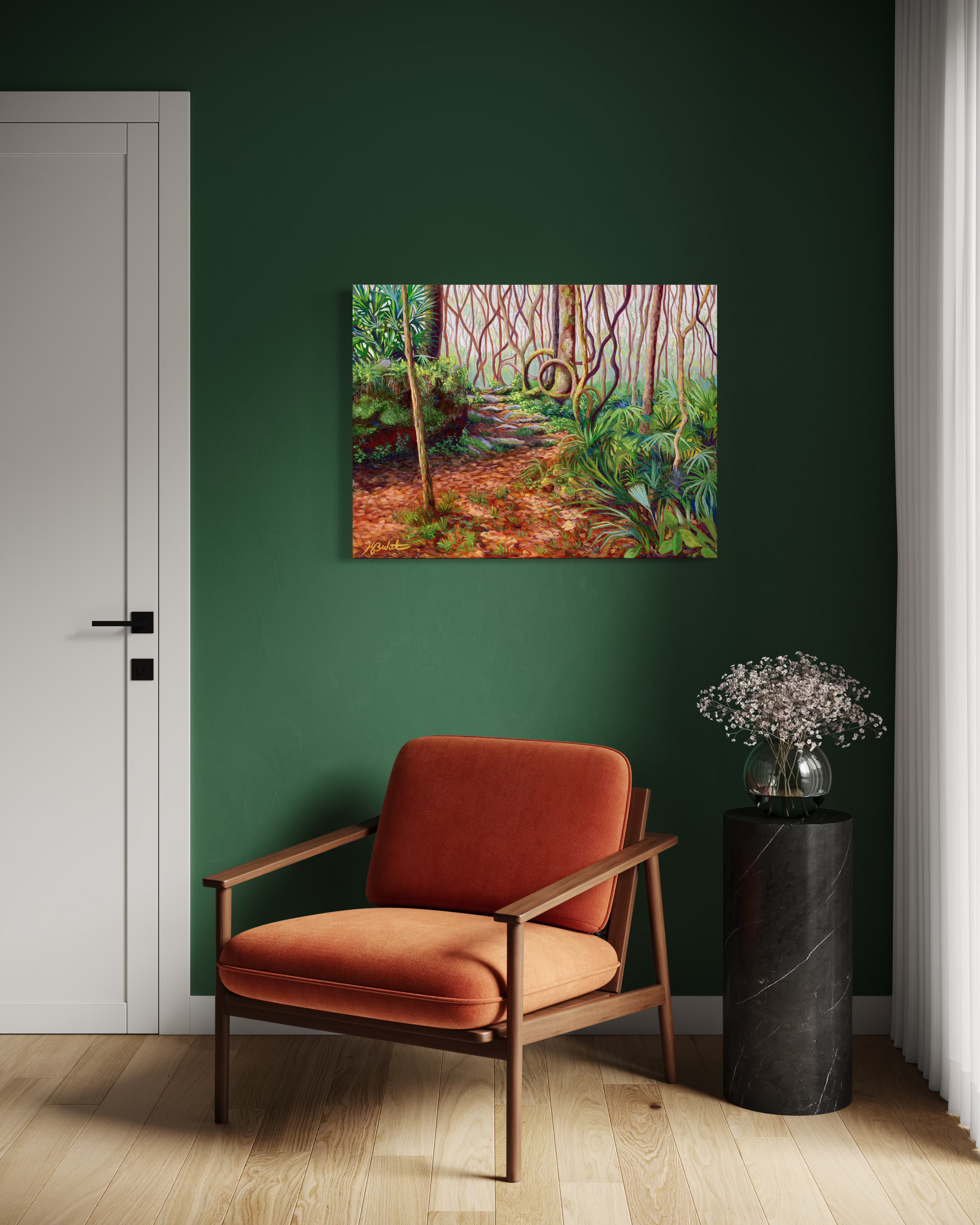 Painting of a forest scene on a green wall above an orange chair.