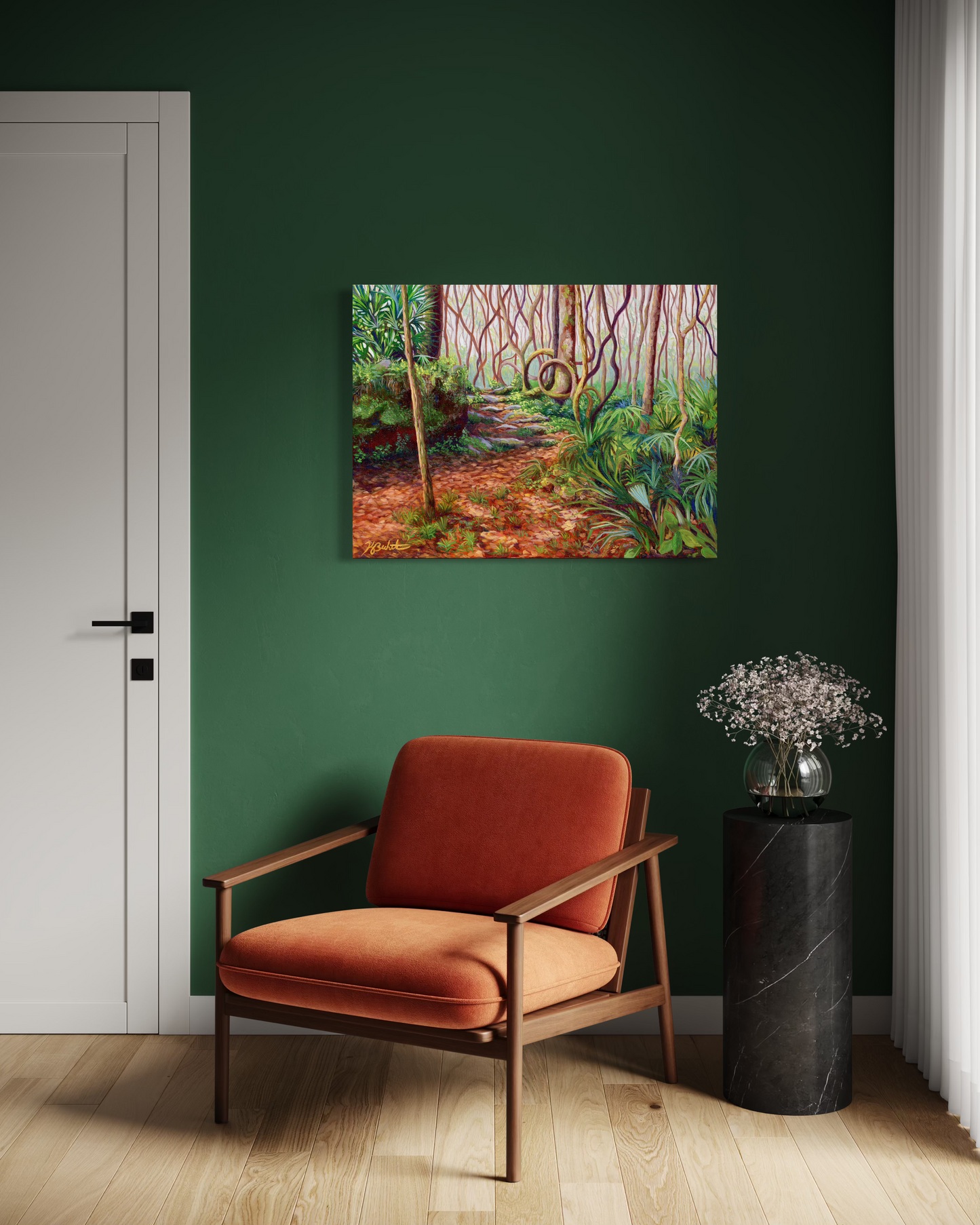 Painting of a forest scene on a green wall above an orange chair.