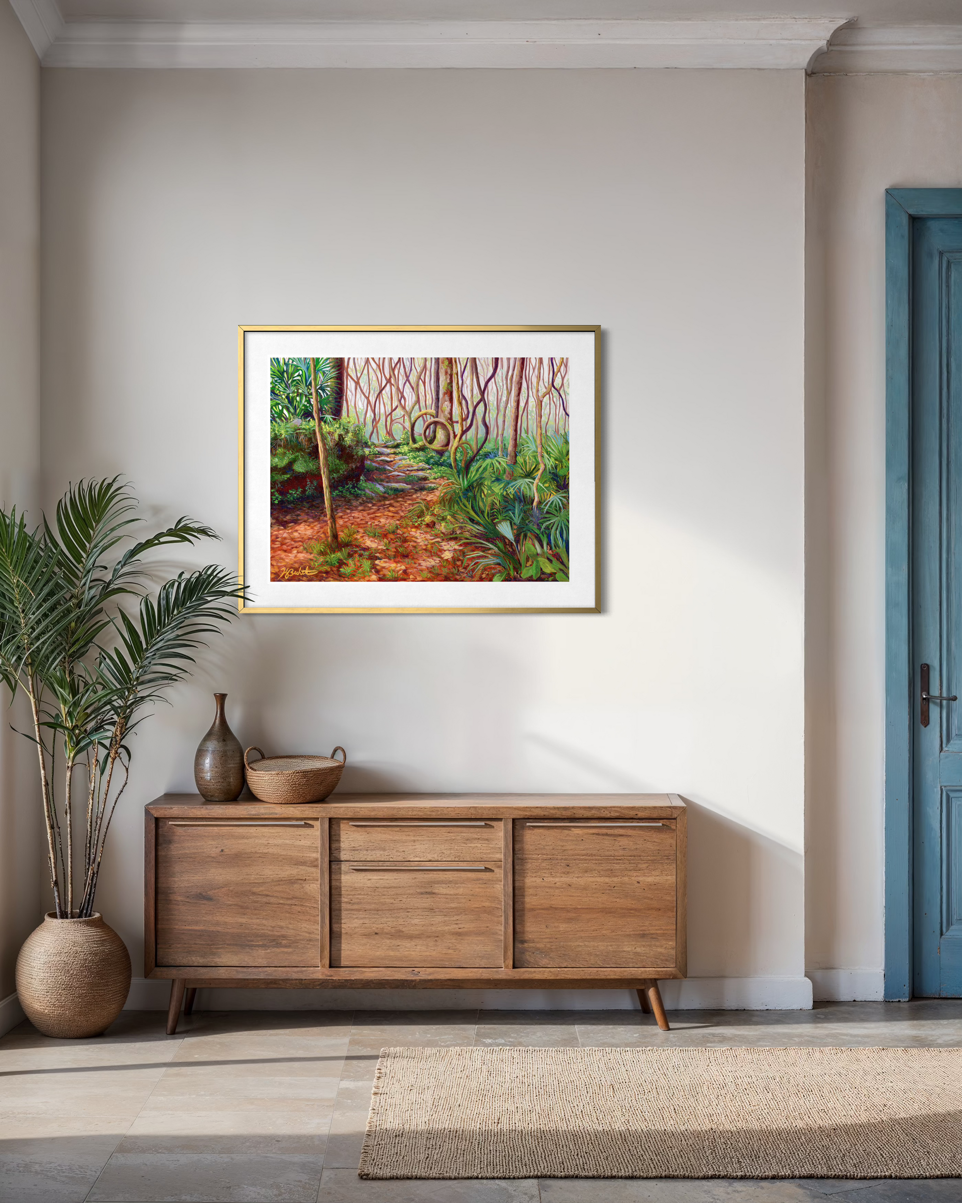 Framed nature painting on a wall above a wooden sideboard with decorative items.
